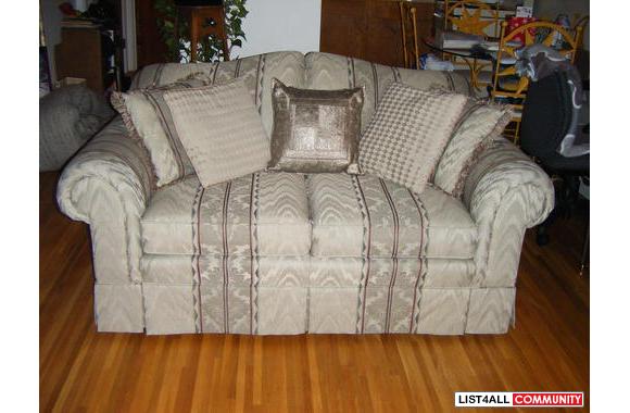 A very nice loveseat that has been covered for 2 y