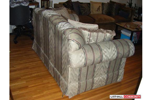 A very nice loveseat that has been covered for 2 y