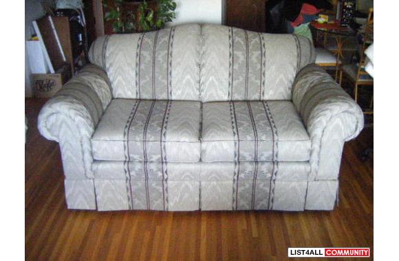 A very nice loveseat that has been covered for 2 y