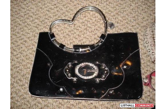 Guess Bag. Never used. Black and silver. Heart shaped handle. Shiny vi
