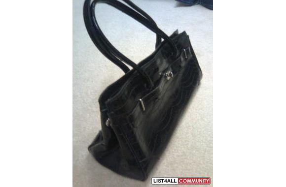Very pretty purse. Black synthetic leather with lock detailing.