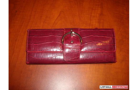 Red pleather wallet. Only inside shows minor signs