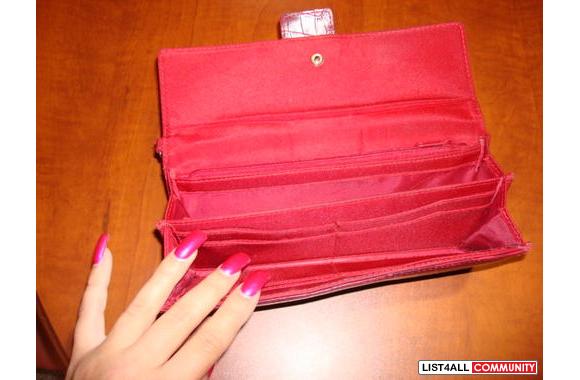 Red pleather wallet. Only inside shows minor signs